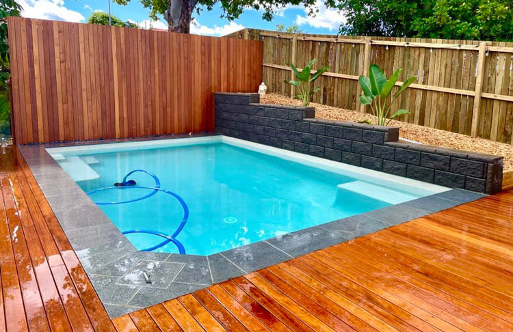 plunge pool with timber deck and retaining wall
